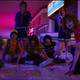 Charlie Heaton, Gaten Matarazzo, Joe Keery, Millie Bobby Brown, Finn Wolfhard, Maya Hawke, Natalia Dyer, Priah Ferguson (obscured), Caleb McLaughlin, Noah Schnapp